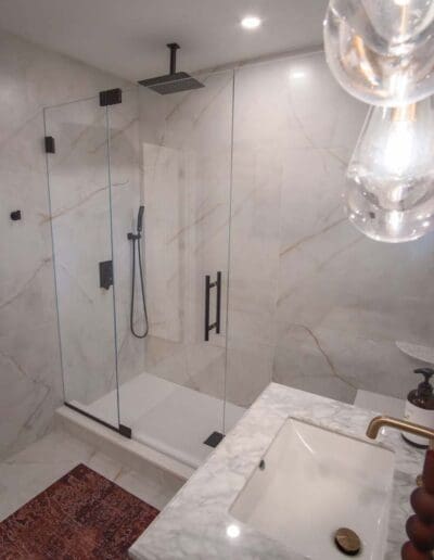 Modern bathroom with glass doors in the shower - interior designer Amherst NH