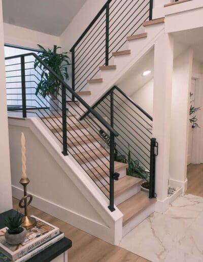 Direct view of white staircase with black railing - interior designer Salem NH