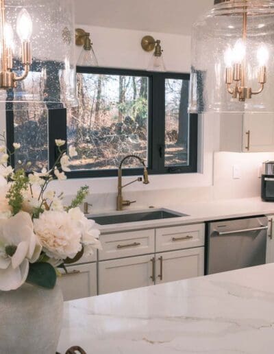 View of kitchen sink area with vintage lamps - interior designer Pelham MA