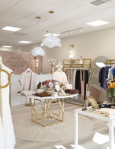 Modern white clothing shop with golden accents - interior designer Merrimack NH