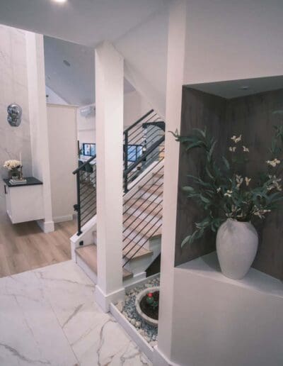 Way to white stairs with black railing - interior designer Merrimack NH