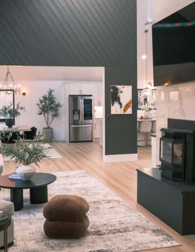 Modern living room with green accent wall and light setup - interior designer Bedford NH