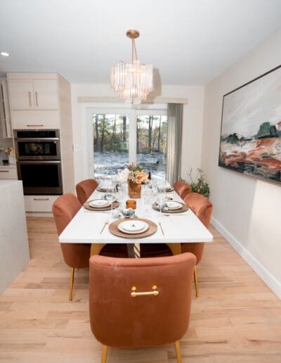 Modern dining table and chairs and elegant ceiling lamp - interior designer Pepperell MA