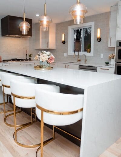 Modern kitchen with isle in the middle in studio lighting - interior designer Amherst