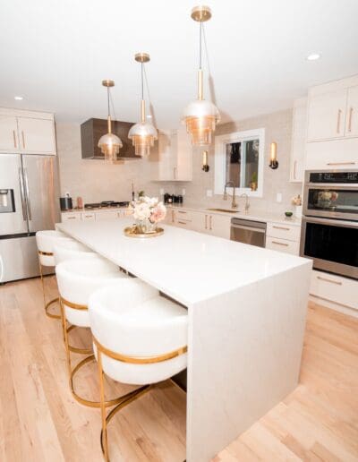 Modern kitchen with isle in the middle in studio lighting - interior designer Amherst