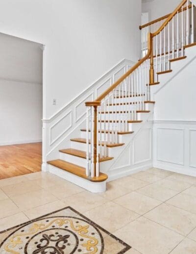 White staircase and living room - interior designer Salem NH