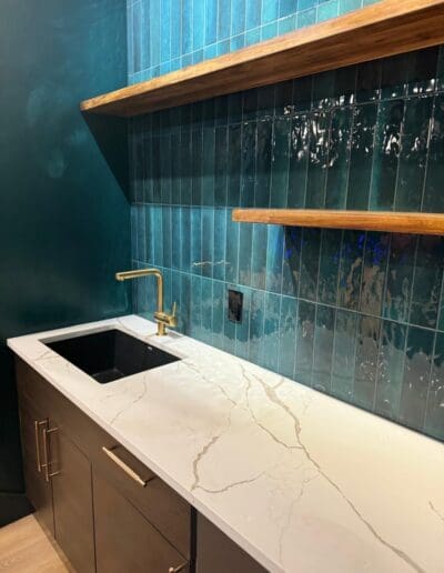 Closeup of remodeled modern teal kitchen sink and shelves - interior designer Windham NH